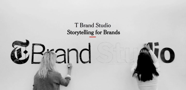 two people drawing t brand studio logo on wall
