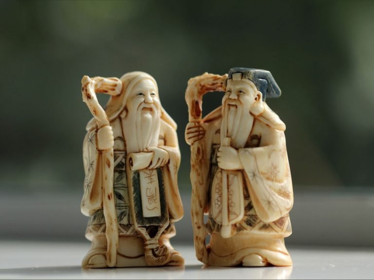 Two small taoist immortals carved in bone
